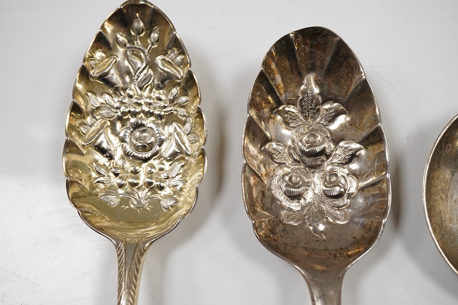 A pair of George III silver gilt Old English pattern berry spoons, London, 1787, 21.8cm, two other earlier silver berry spoons and an Edwardian serving spoon by William Hutton & Sons, London, 1901, 9oz.
